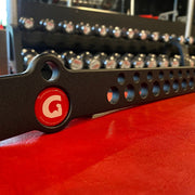 A close-up of a black GymPin D Handle Bar with a red logo sticker, showing the textured black powder coat finish.