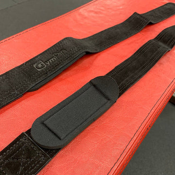 Black straps on a red surface with a visible brand logo.