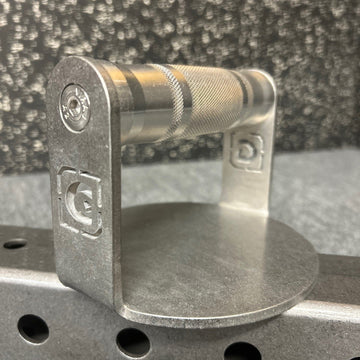 Metallic push-up bracket with brand logo on a textured background