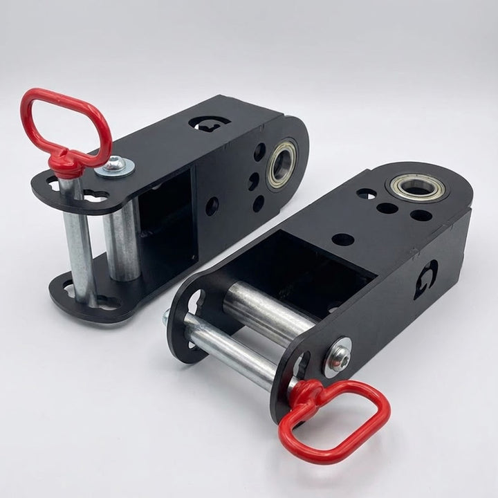 Pair of black heavy-duty GymPin jammer arm adapters with steel rollers and red locking pins, designed for strength training equipment.