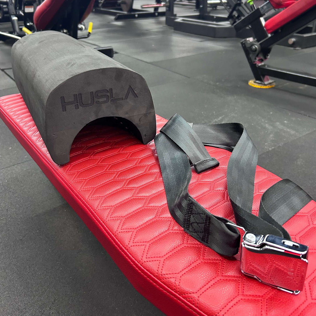 Red weightlifting platform with black strap and &