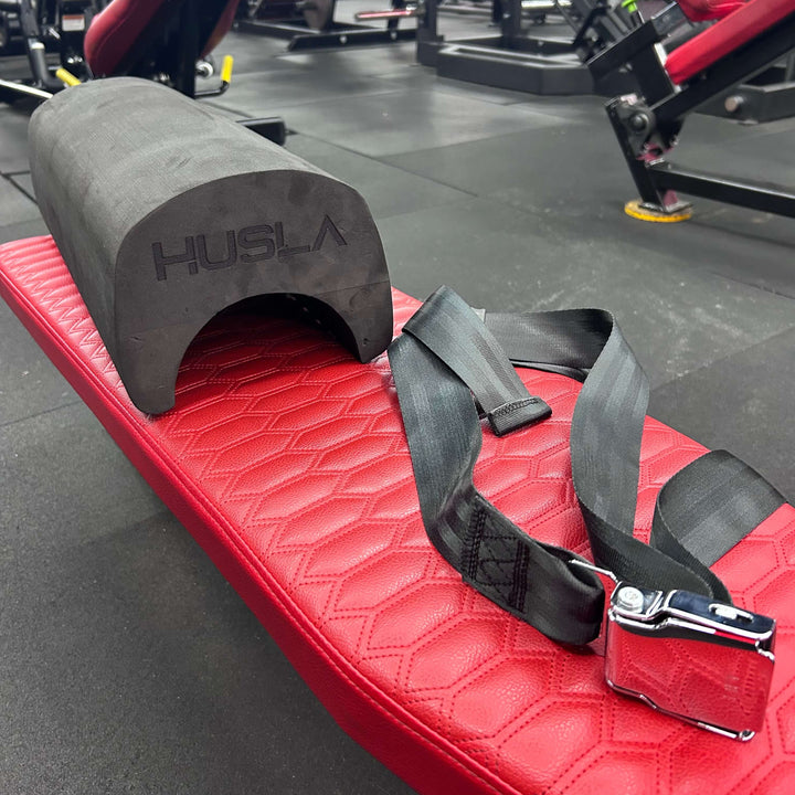 Red weightlifting platform with black strap and &