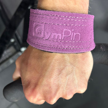 Purple wrist wrap with 'GymPin' branding on a person's wrist.