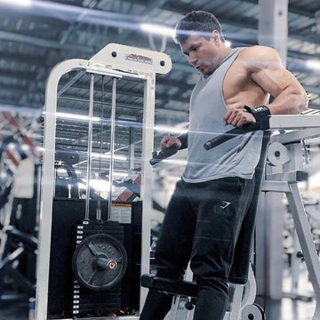 The Original GymPin enhances workouts for strength training using a cable machine with Olympic plates.