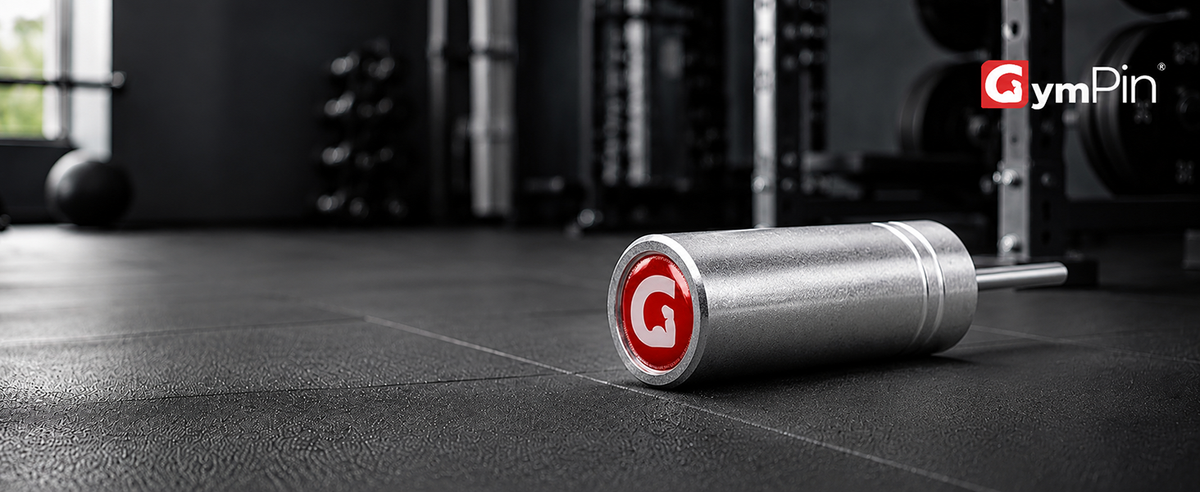 Metal cable stack pin by GymPin with 'GymPin' logo on a gym floor