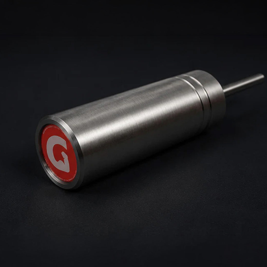 GymPin with a pin protruding out from one end and a red circular end cap featuring a white stylised letter G, photographed on a dark background.