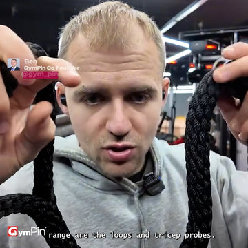 A gym demonstration video showing a man using GymPin Super Long Looped Tricep Ropes on a cable machine. He explains and demonstrates the benefit of the longer rope design, holding the looped ends overhead to show how the extra 1.5 metre length allows fuller elbow flexion and extension during overhead tricep work. Additional clips show the ropes being used for pressdowns and cable tricep movements, highlighting the looped grip design, open-palm hand position and improved control compared with standard short 
