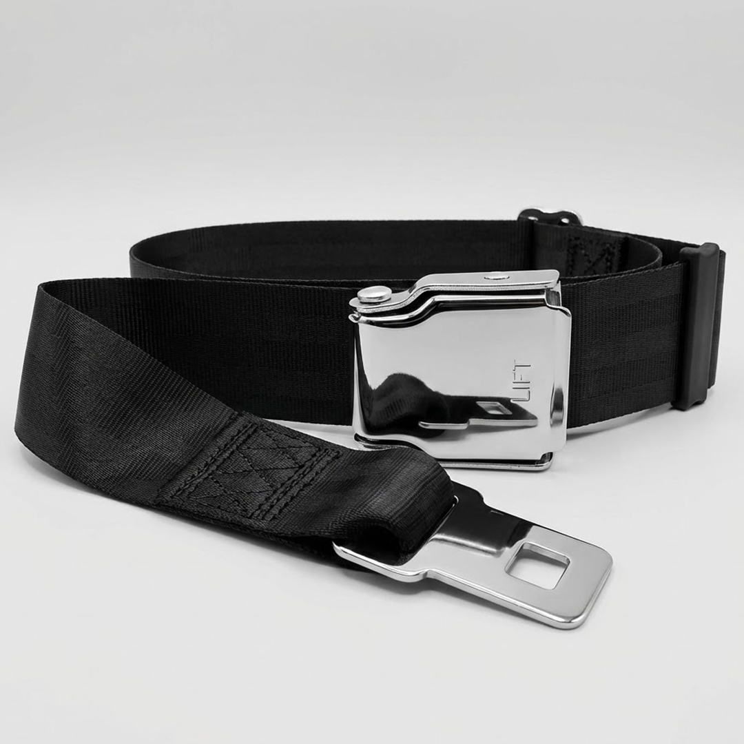 Black seat belt with silver buckle on a light gray background