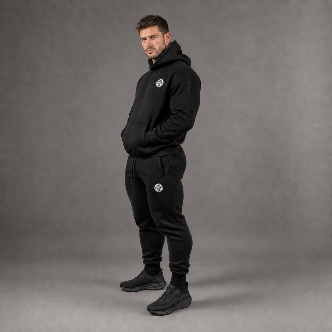 Model wearing the black STACKERS CLUB hoodie and joggers set