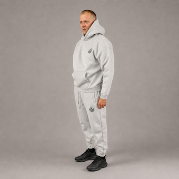 Model wearing the light grey STACKERS CLUB hoodie and joggers set