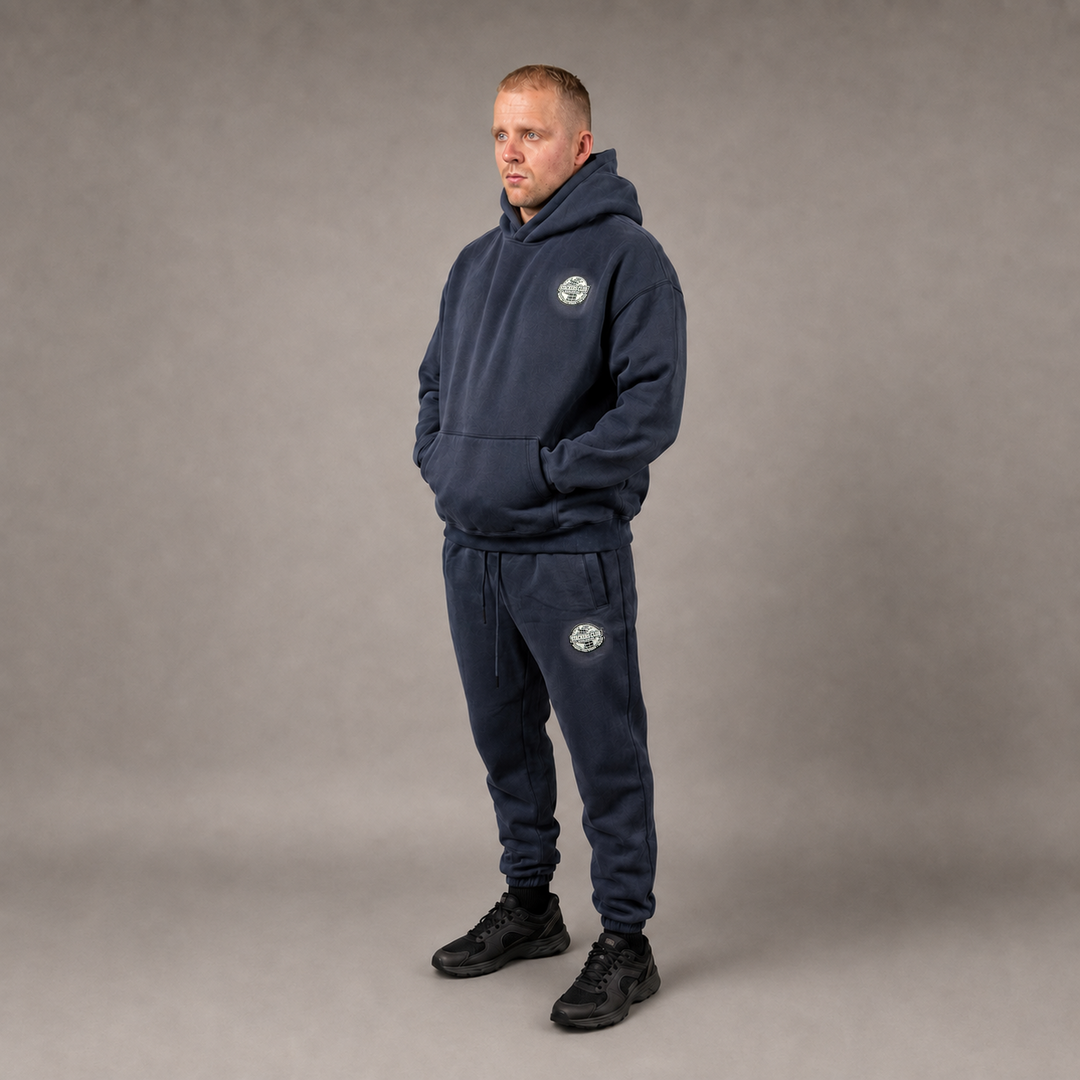 Model wearing the navy STACKERS CLUB hoodie and joggers set