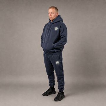 Model wearing the navy STACKERS CLUB hoodie and joggers set