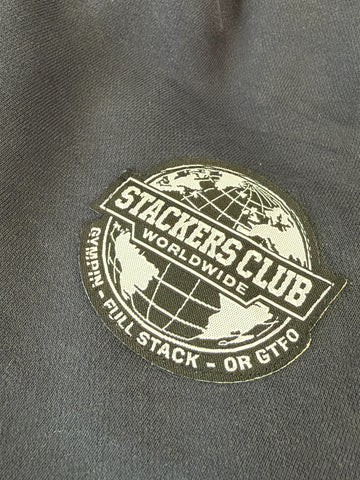 Close-up of the sewn STACKERS CLUB Worldwide woven badge