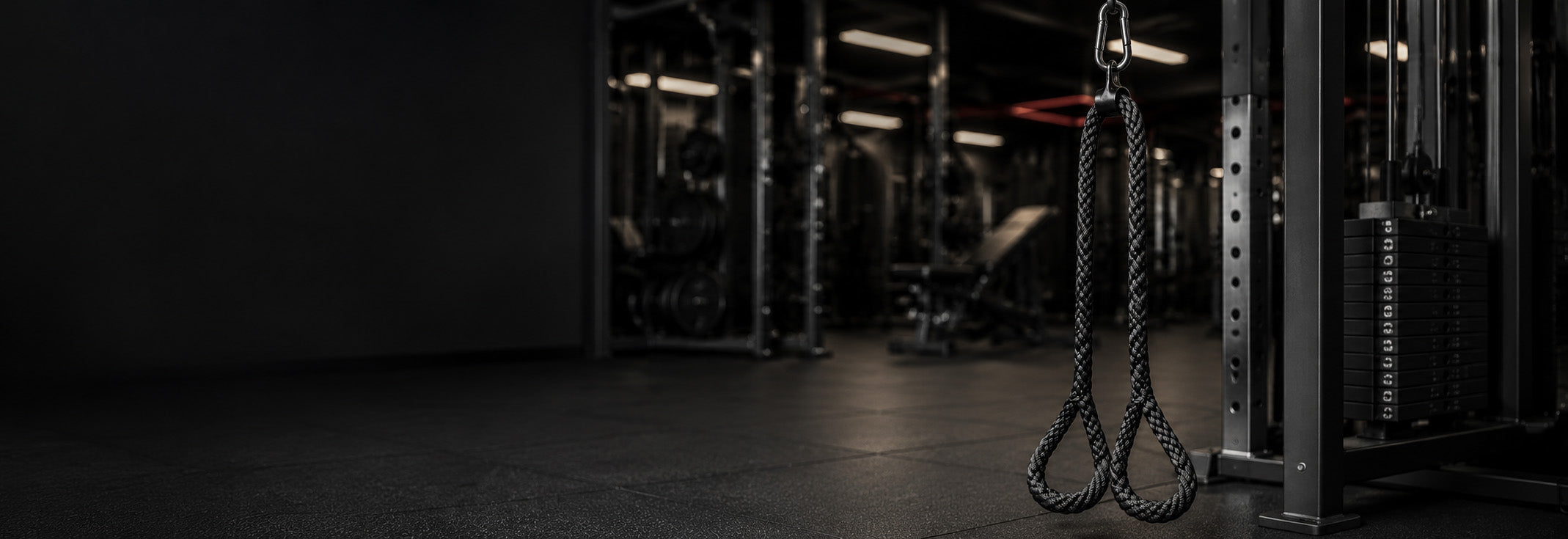 Dark gym interior with a hanging rope loop Super Long Tricep Ropes